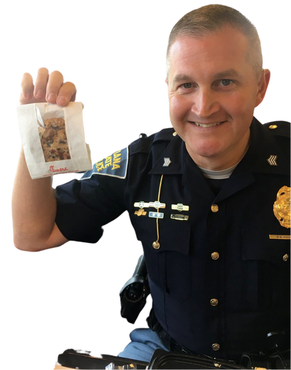 picture of a policeman holding a chick fil a cookie